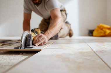 man-kneeling-operating-circular-saw-meticulously-cut-large-format-tile-new-floor-installation-showcasing-renovation-work-construction-activity_1254552-945